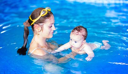 Mother and infant learning to swim