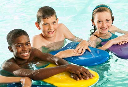 group of pre-teen youths learning to swim