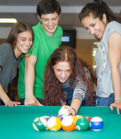 teens playing pool at Y safe space